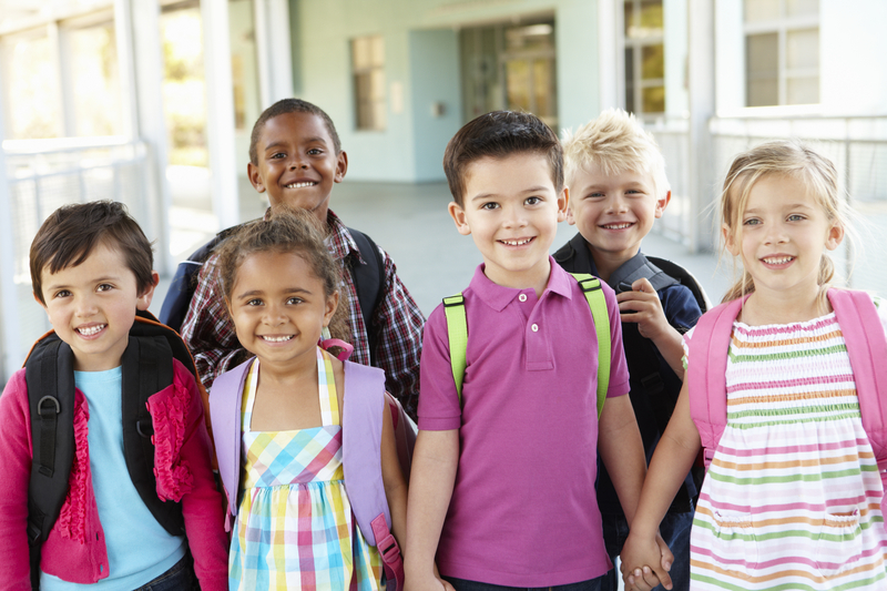 Group Of Elementary Age Schoolchildren Standing Outside